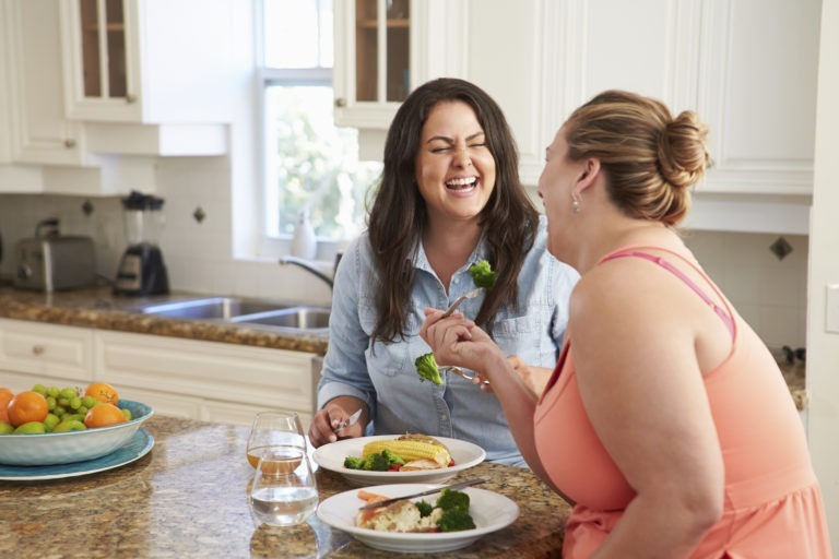 two women eating together at home