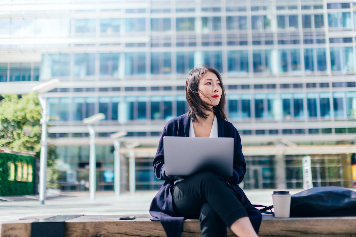 Businesswoman Working With Laptop Outside Practicing Mindfulness