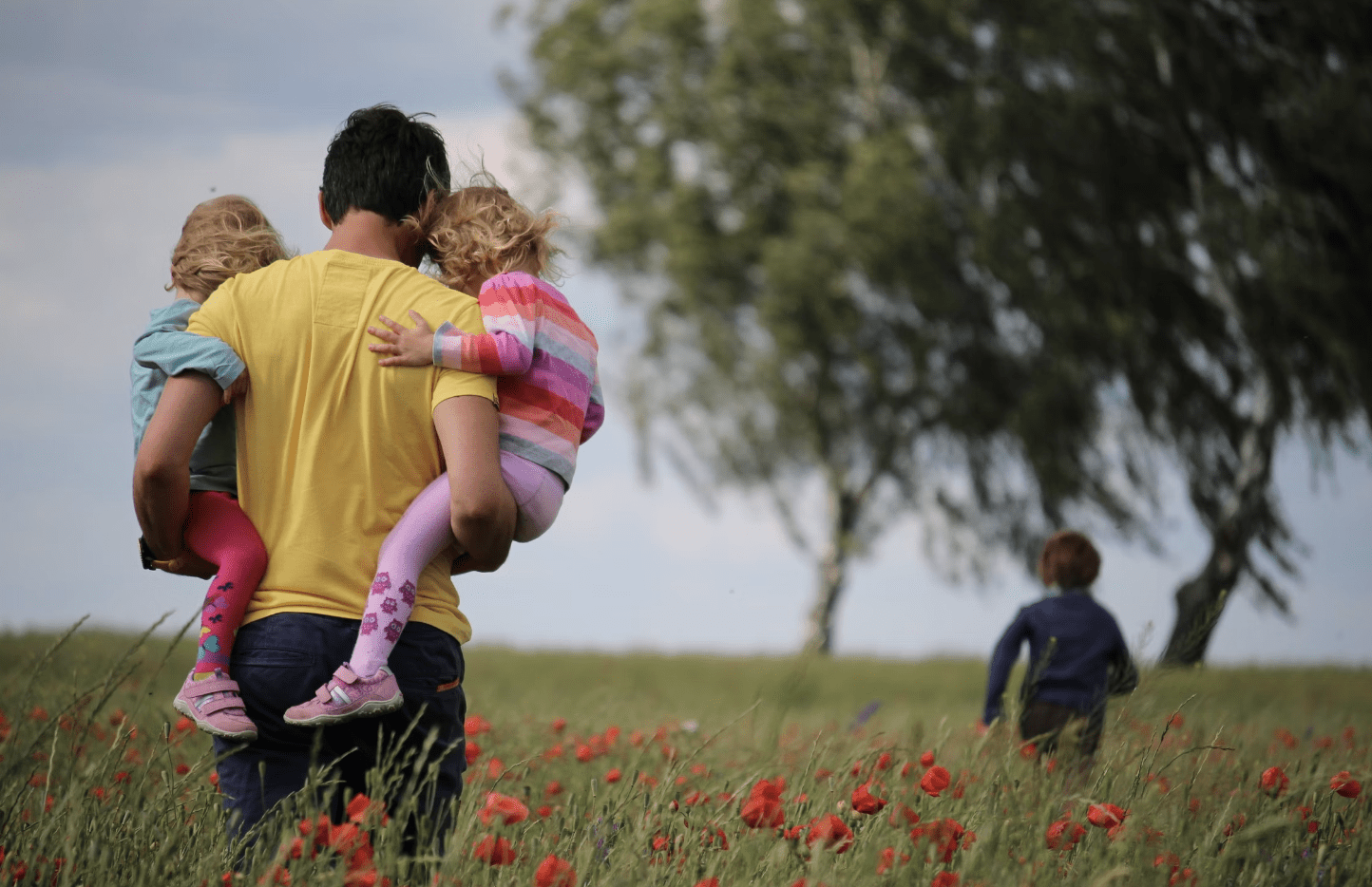 Dad with kids in a field
