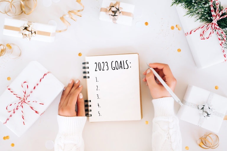 Writing New Year goals 2023 during holiday celebration