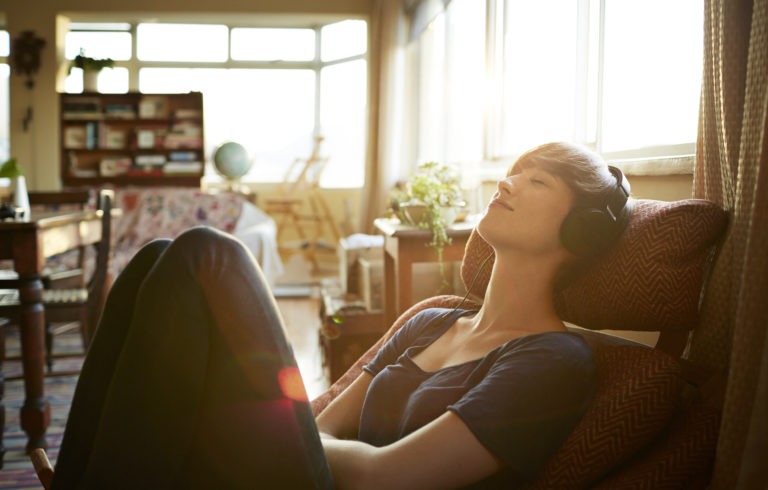 woman listening to harmonious music | Work-life harmony | Limeade