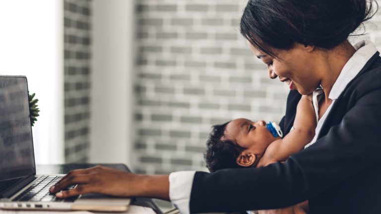 Employee working remotely with a child | Limeade’s employee well-being program