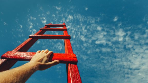 Proactive worker reaching for the sky with unlimited potential | Limeade’s employee engagement program