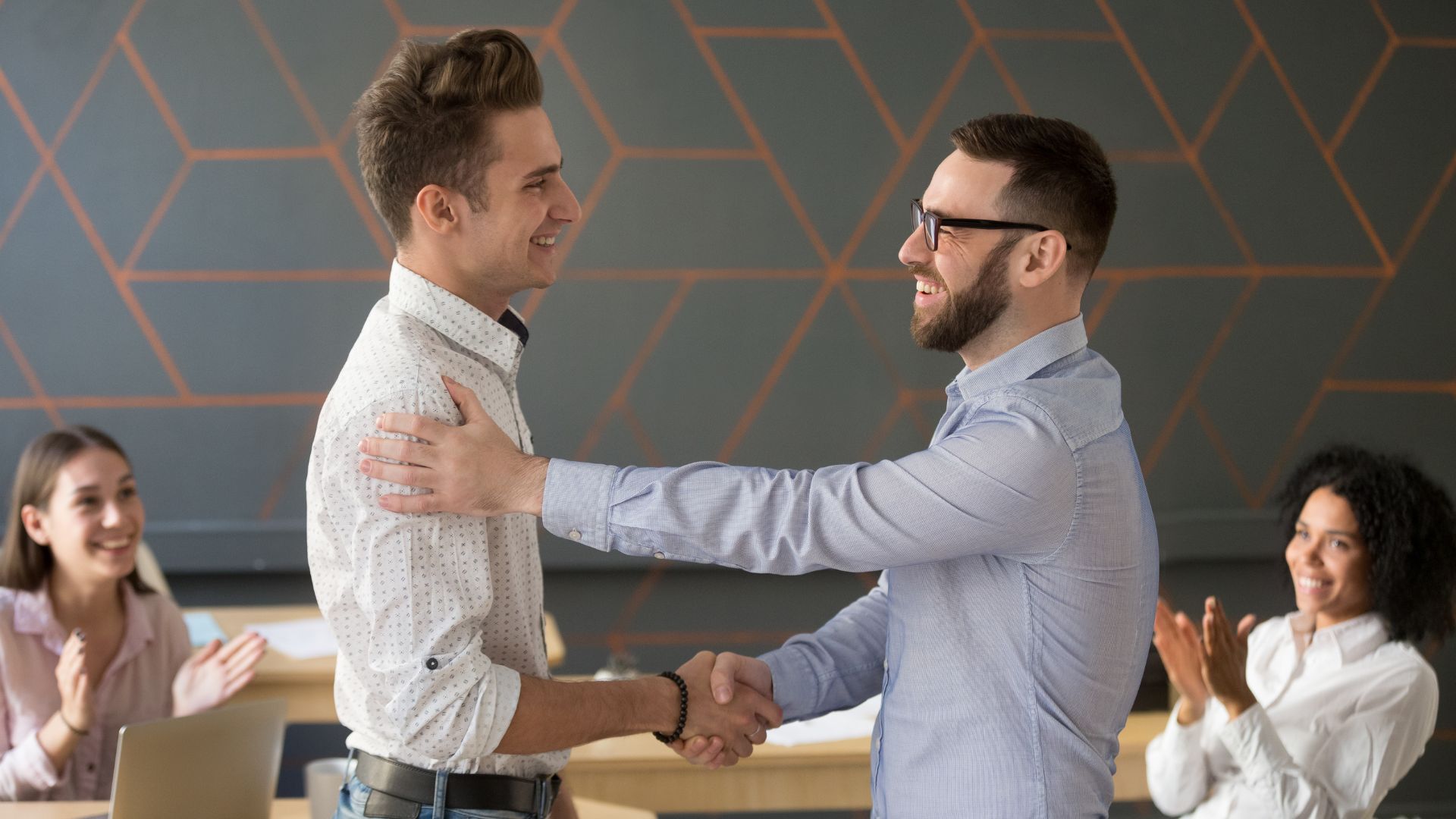 Manager shaking a proactive worker’s hand | Limeade employee engagement program