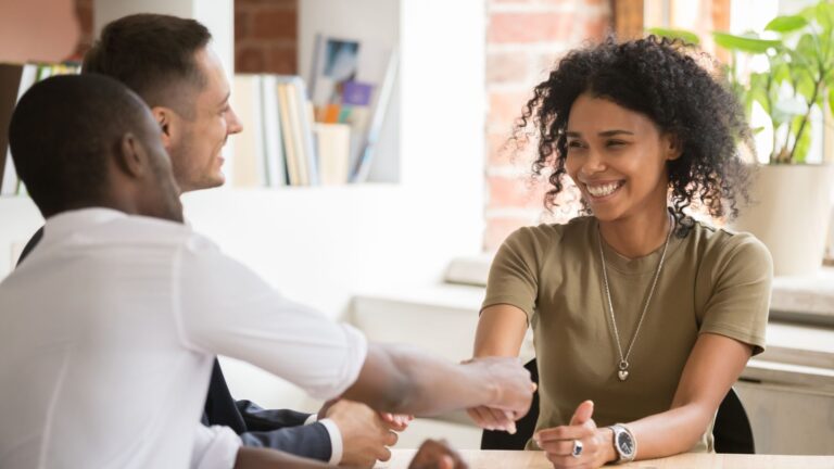 Leader smiles while shaking employee’s hand | Organizational Culture