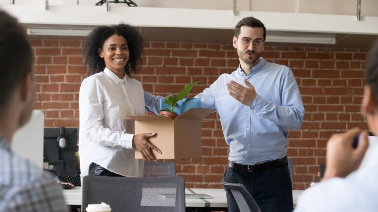 Manager introduces new employee to group as they hold a plant in a cardboard box | Setting Employee Goals